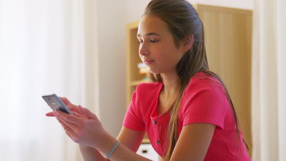 Teenage Girl Texting on Smartphone at Home