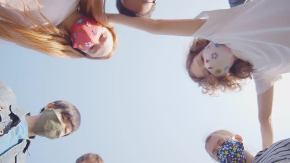 Bottom View of Diverse Kids in Colorful Mask Looking Down at Camera