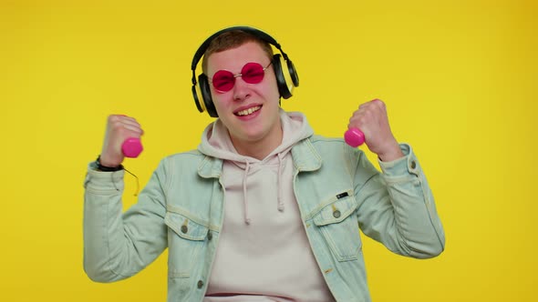 Sporty Teen Student Man Listening Music Via Headphones Working Out Pumping Up Lifting Dumbbells