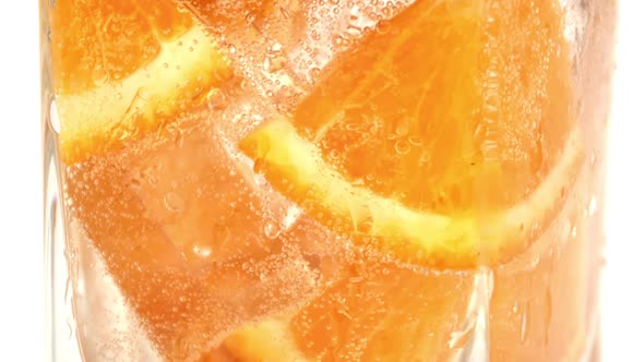 Glass Cool Carbonated Summer Cocktail Fresh Tropical Orange Slice with Fizzy Bubble Macro Shot