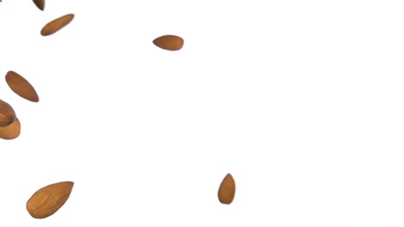 Close Up of Almonds Flying Diagonally on the White Background