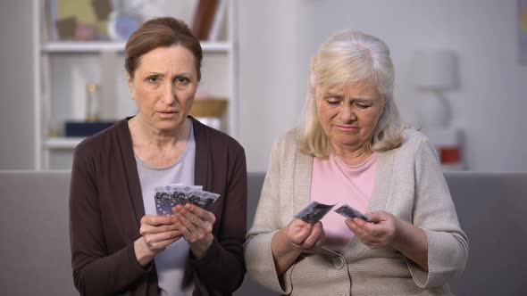 Dissatisfied Elderly Women Showing Euros Banknotes at Camera, Low Incomes