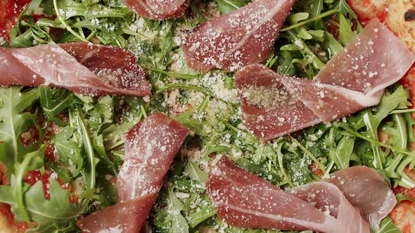 Close Up and Zoom Pizza with Prosciutto Arugula Salad Rocket with Ingredients