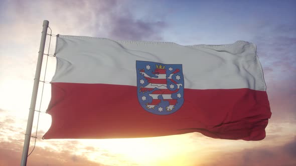 Thuringia Flag Germany Waving in the Wind Sky and Sun Background