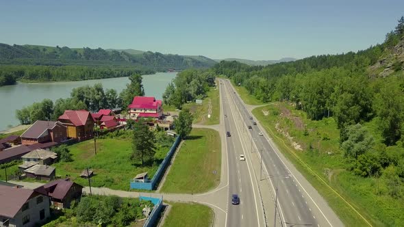 Aerial: Low Level Flying Over the Highway. The View Between the Rock and the Mountain Turquoise