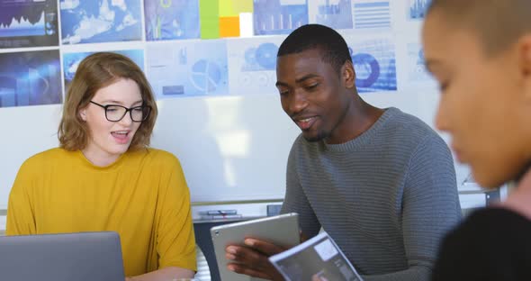 Young mixed race business team over digital tablet in modern office 4k