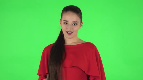 Portrait of Pretty Young Woman Is Making Sign Ok. Green Screen