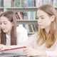 Teen Schoolgirl Working on an Assignment at the Library - VideoHive Item for Sale