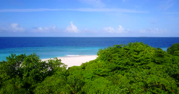 Wide angle drone copy space shot of a white paradise beach and blue water background in hi res 4K