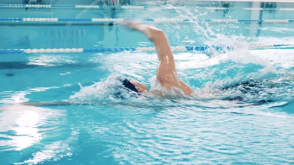 Professional Athlete Performing Breaststroke in a Pool