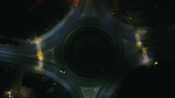 Aerial View Timelapse of Roundabout Road with Circular Cars at Night in Small European City