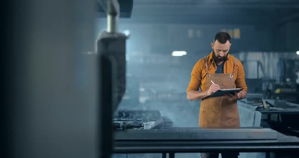 Metal Industry Worker with a Digital Tablet at the Plant