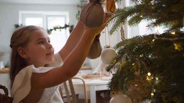 Father and daughter decorating the Christmas tree. Shot with RED helium camera in 8K