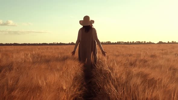 Woman Farmer Wearing Straw Hat Strolls Across Field Wheat Autumn in Rural Area