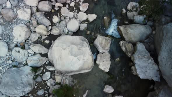 Aerial View of a Small and Clear Mountain River Flowing Between Stones Filmed From Above