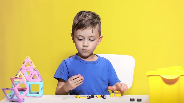 Clever little boy makes car with children's designer.