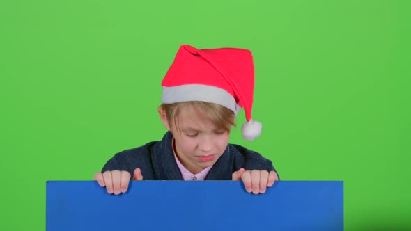 Teen in Cap Rises Holding Hands for the Board on a Green Screen