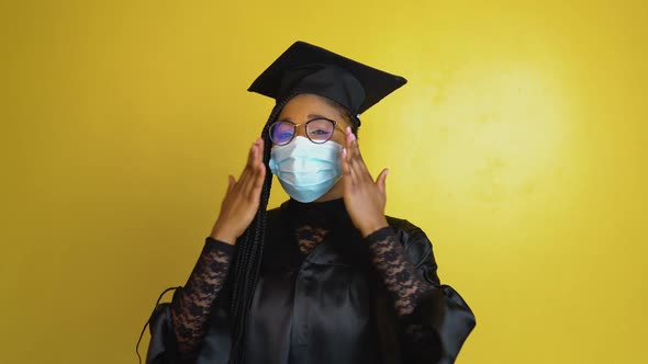 The Graduate Student in a Protective Mask Expresses with Gestures the Need to Comply with Quarantine
