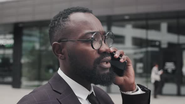 African-American Businessman Talking on Phone and Walking