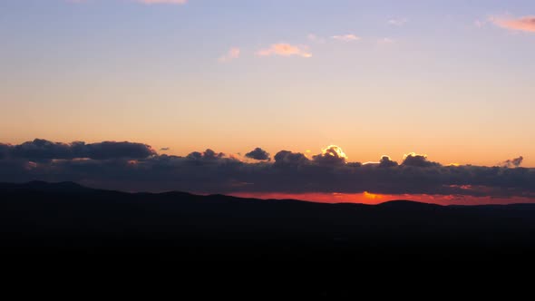 Beautiful Sunset in the Mountains, Sun Shines Through the Clouds