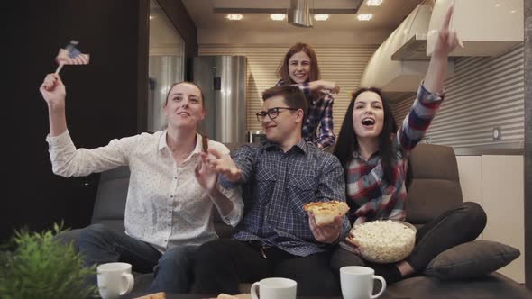 Slow Motion of Young Friends Watching Soccer Football Match on TV Together Eating Popcorn.