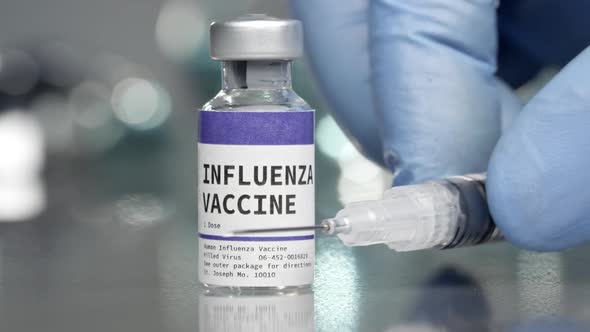 Influenza vaccine in medical lab with syringe