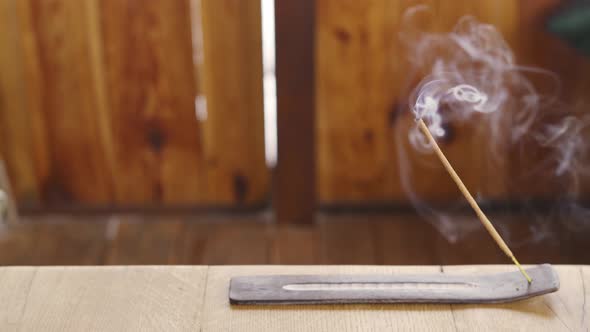 Incense Stick Smokes on a Wooden Table on a Terrace for Pleasant Smells and From Insects