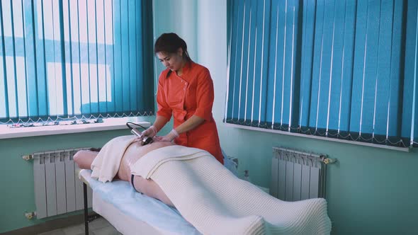 Beautician in Uniform Works with Plussize Woman in Clinic