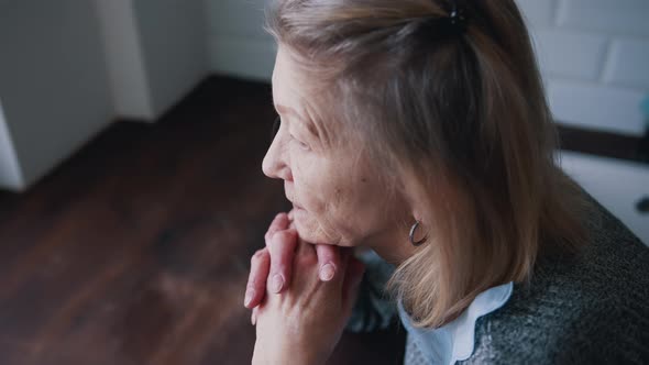 Pensive Lonely Depressed Elderly Woman in Her Home