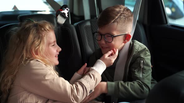 Happy Kids Playing on Back Seat of Car