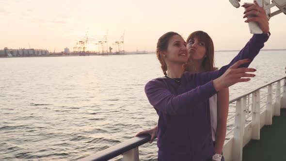 Two Beautiful Women Making Selfie Photo While Enjoying Vacation on a Boat