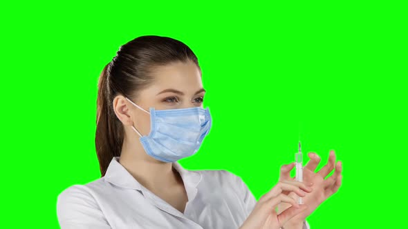 Doctor with Injection. Green Screen. Closeup