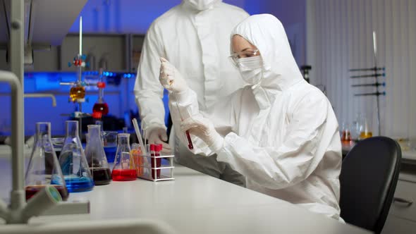 Biologist Examining Sample in Laboratory