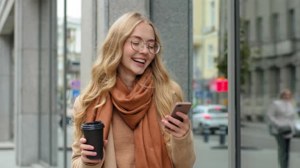Portrait Happy Woman Mobile Phone Outdoors Carries Cup of Coffee in Hand Closeup Cheerful Girl in