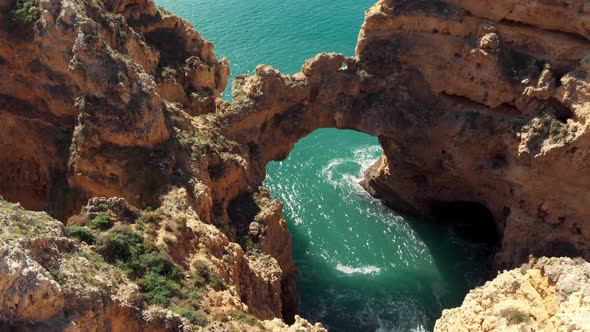 Eroded Stone Arch 'Catedral' above Algarve's Coastline sea in Lagos Portugal