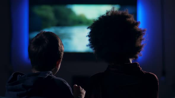 Rear View Teen Boys Watching Movie on Screen