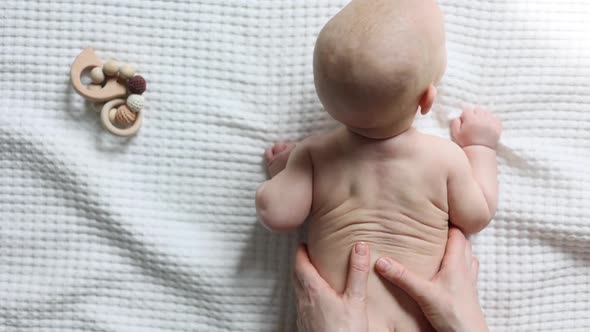 Massaging of Baby Infant's Spine Back