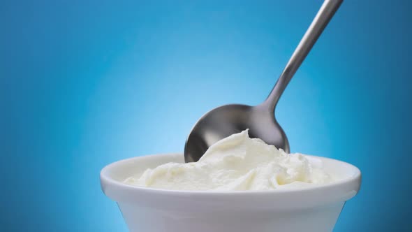 Whipped Cream with Spoon on Blue Background