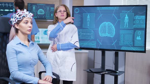 Focused Female Neuroscientist Making Hand Gestures