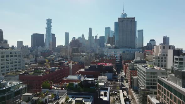 Forwards Fly Above Block of Buildings in City