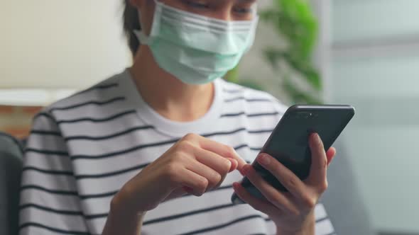 woman wear masks to protect disease and using smartphone, During leisure time.