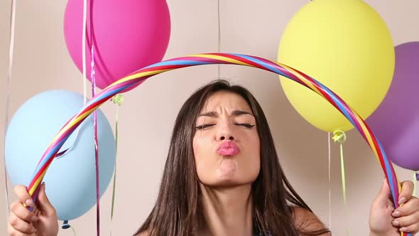 Close up of brunette woman playing with hula hoop in party photo booth