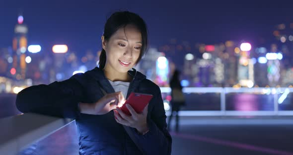 Woman Use of Mobile Phone in City at Night