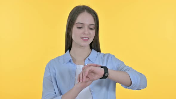 Casual Young Woman Using Smartphone, Yellow Background