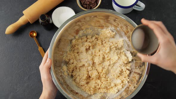 Female Hands Making Dough and Pouring Milk