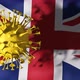 COVID-19 coronavirus cell rotating above UK Great britain England waving flag with shadow. - VideoHive Item for Sale