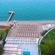 Flight Over the Beach with Umbrellas Towards the Pool in a Luxury Hotel - VideoHive Item for Sale
