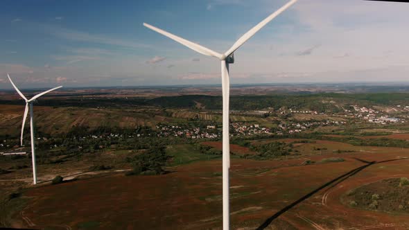Camera Flight Over Landscape with Power Plant. Aerial View To Wind Turbine. Sustainable Electricity