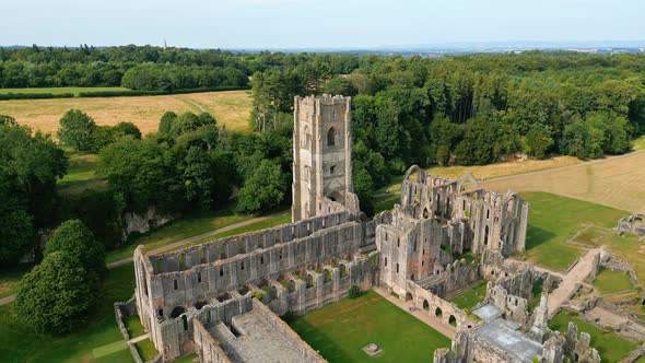 Drone aerial footage of the  historical 13th century Fountains Abby ruins - North Yorkshire - Englan