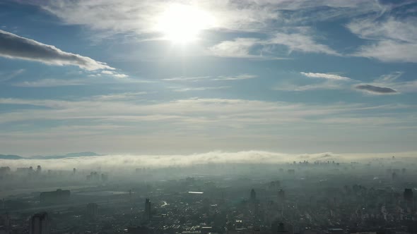 Fog morning at downtown district. Above the clouds.